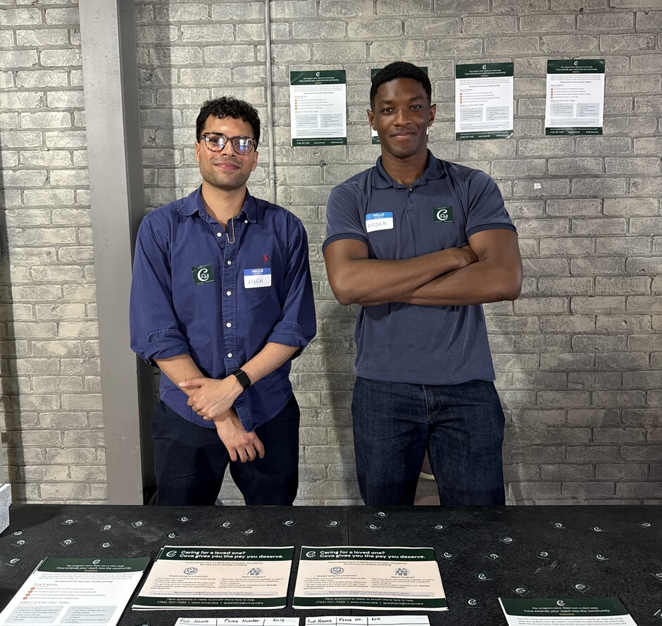 Cova co-founders Ansh Tandon and Jordan Ibe behind a table of Cova information sheets